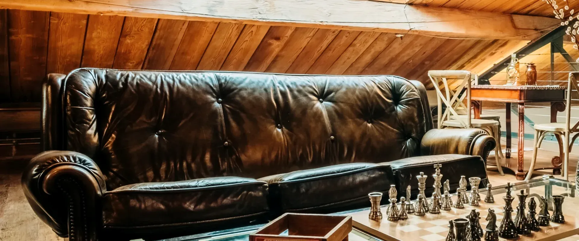 Detail of the chesterfield leather sofa beside the gas-lit fireplace in the upstairs loft.